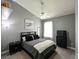 This bedroom offers neutral gray walls, ceiling fan, and a stylish, comfortable sleeping space at 30623 Bittsbury Ct, Wesley Chapel, FL 33543
