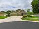 Attractive two-story home featuring manicured landscaping, a three-car garage, and stone facade at 30623 Bittsbury Ct, Wesley Chapel, FL 33543