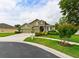 Attractive two-story home with a stone-accented entryway, a well-maintained lawn, and a three-car garage at 30623 Bittsbury Ct, Wesley Chapel, FL 33543