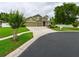 Traditional-style home with a three-car garage, stone accents, and a well-manicured, landscaped yard at 30623 Bittsbury Ct, Wesley Chapel, FL 33543