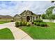 Beautiful two-story home with a stone facade, manicured shrubs, and a well-maintained lawn at 30623 Bittsbury Ct, Wesley Chapel, FL 33543