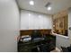 Functional office area, featuring built-in cabinets and ample workspace at 30623 Bittsbury Ct, Wesley Chapel, FL 33543