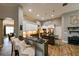 Modern kitchen with stainless steel appliances, pendant lighting, and breakfast bar seating, perfect for cooking at 30623 Bittsbury Ct, Wesley Chapel, FL 33543