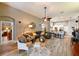 Stylish living room that flows to kitchen, featuring modern furniture, a large rug, and abundant natural light at 30623 Bittsbury Ct, Wesley Chapel, FL 33543