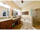 Bright main bathroom with double vanities, soaking tub, and walk-in shower at 30623 Bittsbury Ct, Wesley Chapel, FL 33543