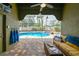 Open view from the covered patio of the screened-in pool and well-maintained landscaping at 30623 Bittsbury Ct, Wesley Chapel, FL 33543