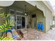 Covered patio with a ceiling fan, comfortable seating, mounted television, and brick floors at 30623 Bittsbury Ct, Wesley Chapel, FL 33543