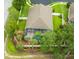 Aerial view of a screened-in pool surrounded by mature trees and lush landscaping in the backyard at 30623 Bittsbury Ct, Wesley Chapel, FL 33543