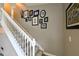 Carpeted stairway with white banister and decorative wall hangings at 30623 Bittsbury Ct, Wesley Chapel, FL 33543