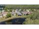 Beautiful aerial view of multiple homes with lake, natural landscaping, and community at 3219 Gianna Way, Land O Lakes, FL 34638