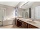 A spacious bathroom features double vanities, a soaking tub, and a separate shower at 3219 Gianna Way, Land O Lakes, FL 34638