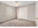 A light-filled bedroom showcases wall shelving, a ceiling fan, and a double-door closet at 3219 Gianna Way, Land O Lakes, FL 34638