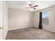 A carpeted bedroom has a ceiling fan and a window with blind and curtains at 3219 Gianna Way, Land O Lakes, FL 34638