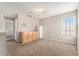 Carpeted bonus room offers a kitchenette with a sink, cabinets, and a mini refrigerator at 3219 Gianna Way, Land O Lakes, FL 34638