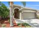 Charming single-story home with a well-manicured lawn, mature palm trees, and a welcoming entrance at 3219 Gianna Way, Land O Lakes, FL 34638