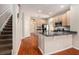 Bright kitchen features stainless appliances, granite countertops, and convenient breakfast bar at 3219 Gianna Way, Land O Lakes, FL 34638