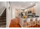 Open kitchen features stainless steel appliances, granite countertops, and breakfast bar seating at 3219 Gianna Way, Land O Lakes, FL 34638