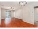 Open living room with hardwood floors and a sliding door, offering natural light and easy access to the outdoors at 3219 Gianna Way, Land O Lakes, FL 34638
