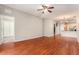 Open-concept living room with wood floors leading to the kitchen and dining area at 3219 Gianna Way, Land O Lakes, FL 34638