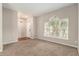 Carpeted living room with a large window and light fixture at 3219 Gianna Way, Land O Lakes, FL 34638