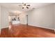 Large living room with wood floors, ceiling fan, and view to kitchen at 3219 Gianna Way, Land O Lakes, FL 34638