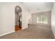 Open living area with view into kitchen and dining, neutral paint and carpet at 3219 Gianna Way, Land O Lakes, FL 34638