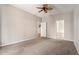 Bedroom features ceiling fan, carpet and neutral paint with entry to bathroom and closet at 3219 Gianna Way, Land O Lakes, FL 34638