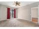 Primary bedroom features sliding glass door to the patio, neutral paint, and carpet at 3219 Gianna Way, Land O Lakes, FL 34638