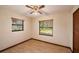 Cozy bedroom featuring two windows with natural light and a ceiling fan for added comfort at 34796 Hibiscus St, Dade City, FL 33525