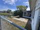 View of the backyard with access to water, enhanced by a screened enclosure and partial fencing at 3542 Delta Pl, Holiday, FL 34691