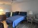 Comfortable bedroom with a twin bed, wood-look flooring and vintage luggage decor at 3542 Delta Pl, Holiday, FL 34691