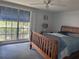 Bedroom with wooden bed frame, bright natural light from a large window, and tile flooring at 3542 Delta Pl, Holiday, FL 34691