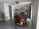 Dining room with a dark wood table, 6 chairs, tile floor, and natural lighting at 3542 Delta Pl, Holiday, FL 34691