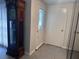 Home entryway with tiled floors, a decorative front door, and a classic grandfather clock at 3542 Delta Pl, Holiday, FL 34691