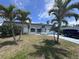 Beautiful single-story home with palm trees in the front yard and an attached one car garage at 3542 Delta Pl, Holiday, FL 34691