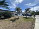 Beautiful single-story home with palm trees in the front yard and an attached one car garage at 3542 Delta Pl, Holiday, FL 34691