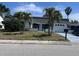 Charming single-story home with light exterior paint, beautiful palm trees, and an attached garage at 3542 Delta Pl, Holiday, FL 34691