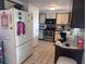 Functional kitchen featuring white appliances, neutral-toned cabinetry, and durable tile flooring at 3542 Delta Pl, Holiday, FL 34691