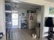 Bright kitchen with tile flooring, equipped with essential appliances and storage, adjacent to living area at 3542 Delta Pl, Holiday, FL 34691