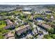 Aerial view of condos with a community pool, parking, and commercial areas nearby at 4002 Crockers Lake Blvd # 1-128, Sarasota, FL 34238
