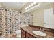 Neutral bathroom featuring a granite countertop, single sink, and shower with patterned curtain at 4002 Crockers Lake Blvd # 1-128, Sarasota, FL 34238