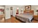 Bedroom with hardwood floors, queen bed with wooden headboard, walk-in closet and ensuite bathroom at 4002 Crockers Lake Blvd # 1-128, Sarasota, FL 34238
