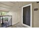 Condo front entrance featuring a dark painted front door and views of the outdoor surroundings at 4002 Crockers Lake Blvd # 1-128, Sarasota, FL 34238