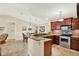 Well-lit kitchen with stainless steel appliances, granite countertops, and a breakfast bar at 4002 Crockers Lake Blvd # 1-128, Sarasota, FL 34238