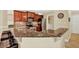 Open kitchen featuring granite countertops, stainless steel appliances, and cherry cabinets at 4002 Crockers Lake Blvd # 1-128, Sarasota, FL 34238