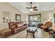 Comfortable living room with neutral tones, large windows, and a ceiling fan at 4002 Crockers Lake Blvd # 1-128, Sarasota, FL 34238