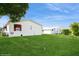 Lush green backyard with well-maintained lawn and charming home exteriors, creating a serene outdoor space at 472 Trout Ln, Oldsmar, FL 34677