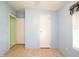 View of a light-blue bedroom featuring a white door to another room at 472 Trout Ln, Oldsmar, FL 34677