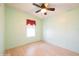 Clean, light-green bedroom with a window and neutral-toned wood floors and ceiling fan at 472 Trout Ln, Oldsmar, FL 34677