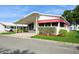 Attractive home exterior with covered parking and manicured landscaping, showcasing curb appeal and welcoming ambiance at 472 Trout Ln, Oldsmar, FL 34677